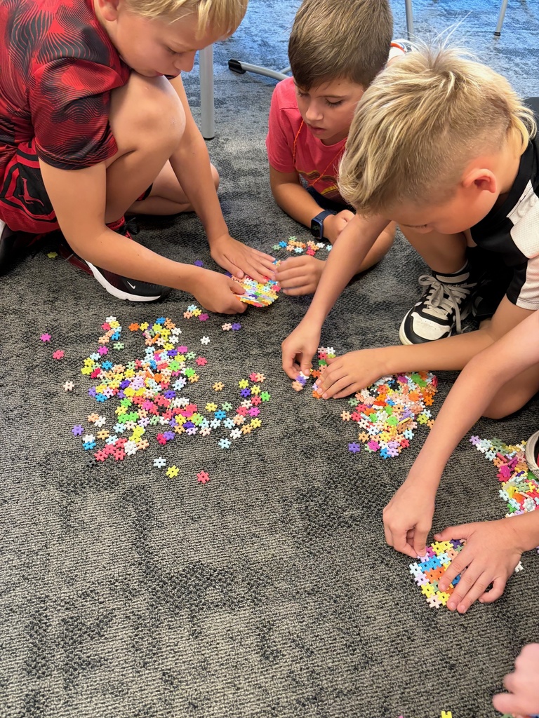3rd grade students using counting strategies to count a large pile of small objects