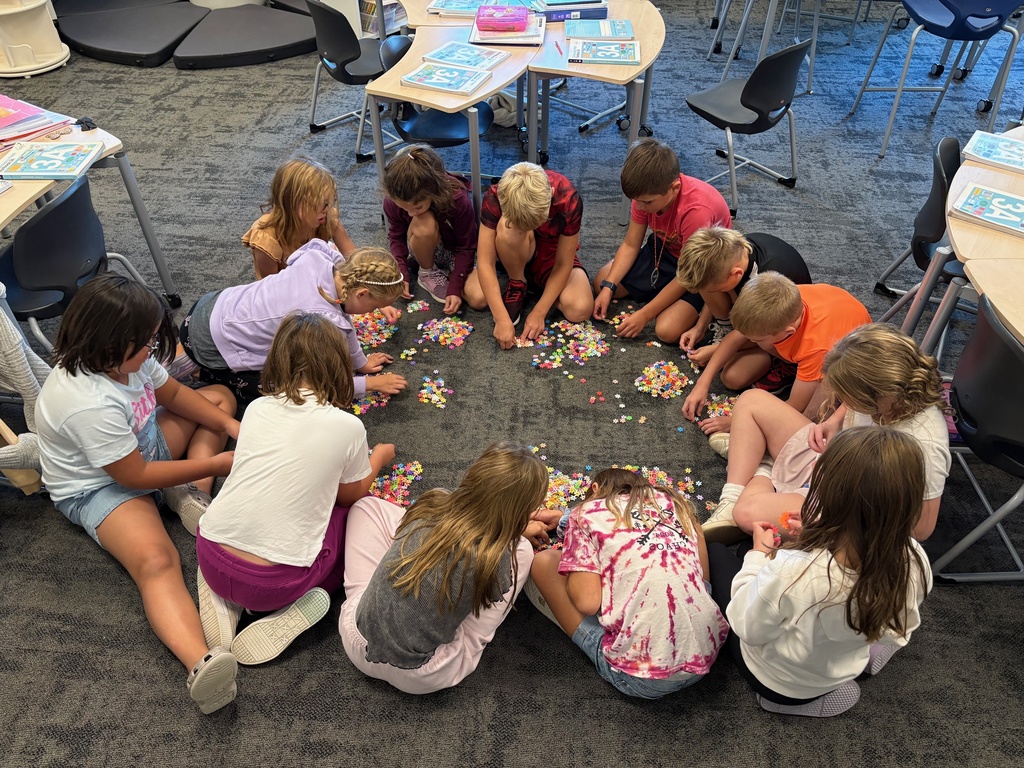 3rd grade students using counting strategies to count a large pile of small objects