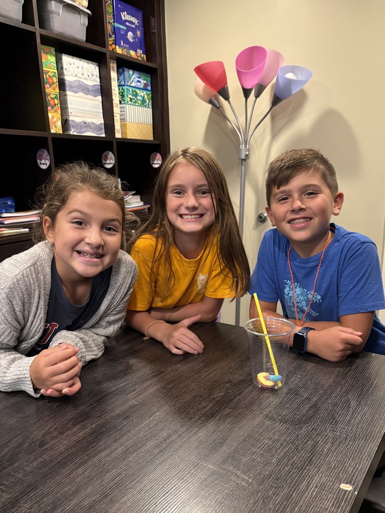 3rd grade students smiling after they had solved a problem as a team