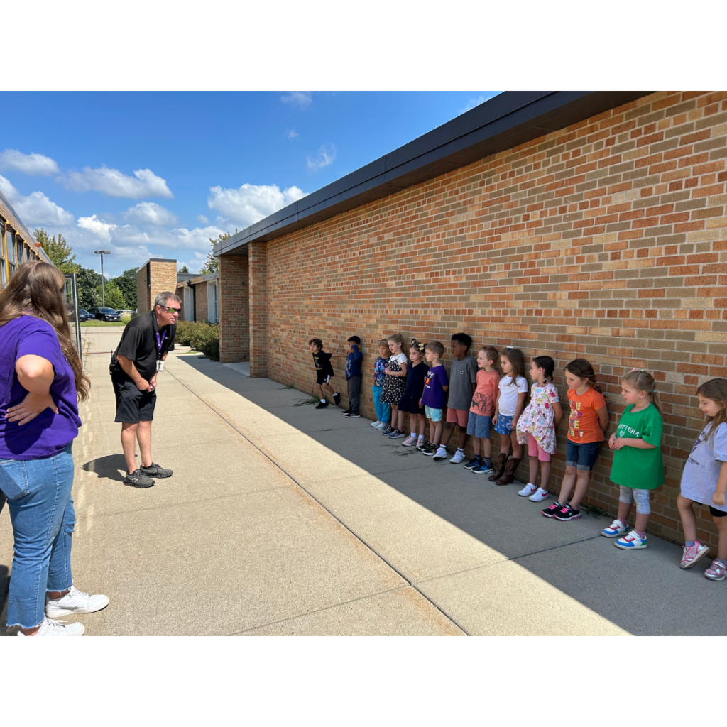 bus driver talking to kindergarten students