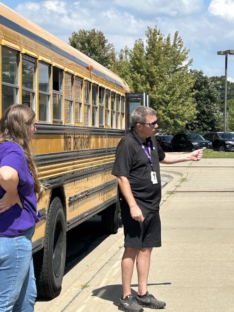 bus driver talking to kindergarten students