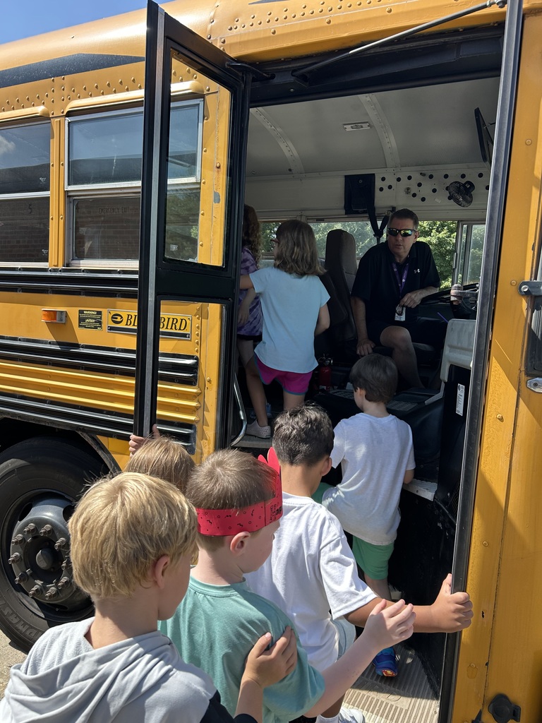 students lined up to get on the bus