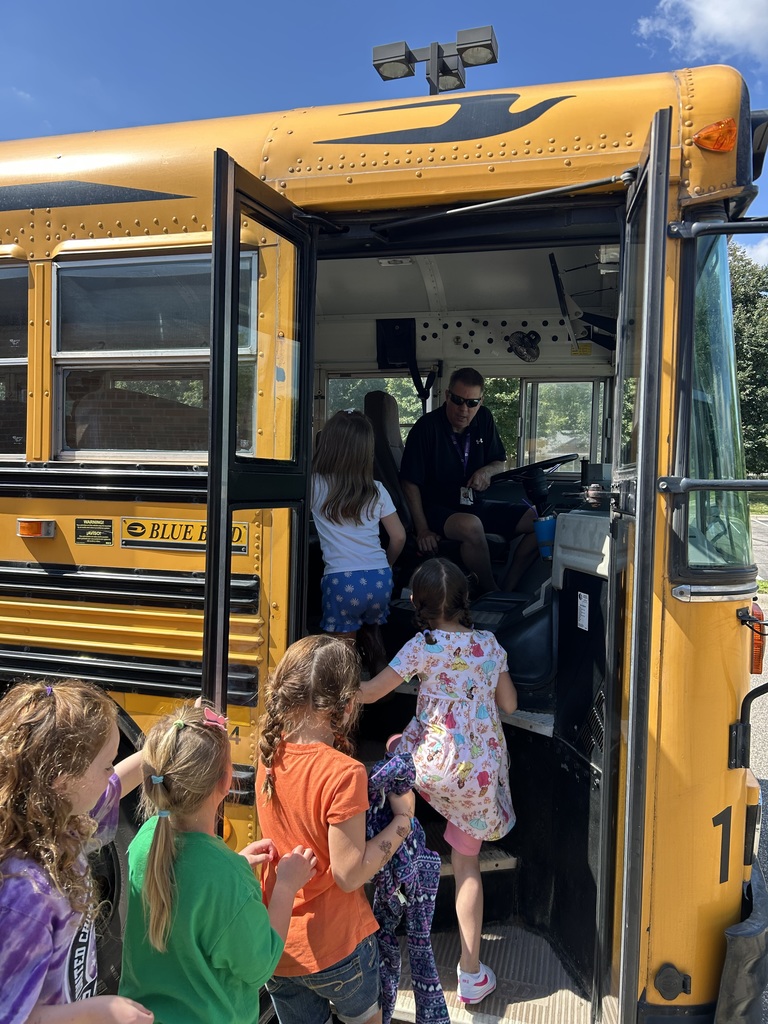 students lined up to get on the bus