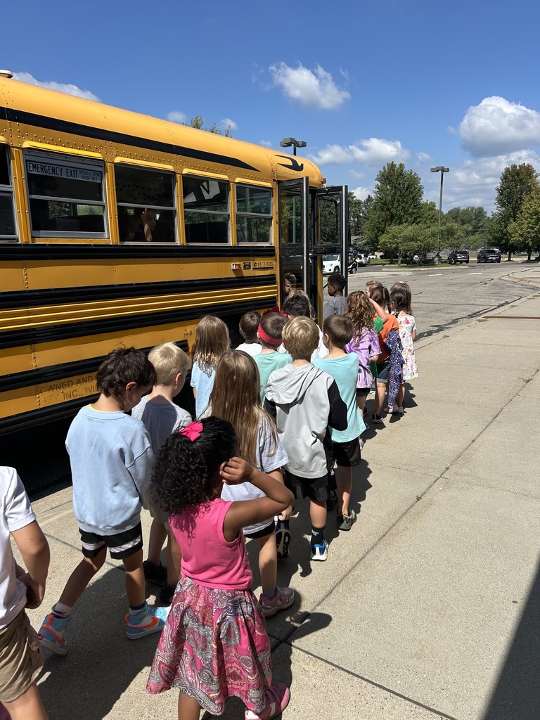 students lined up to get on the bus