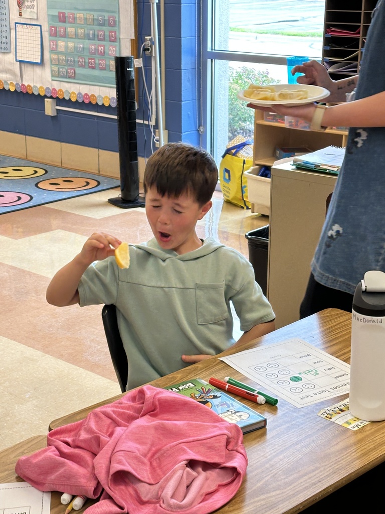 student making a funny face after tasting a lemon
