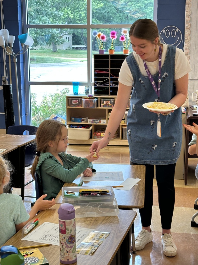 teacher handing a student a slice of lemon