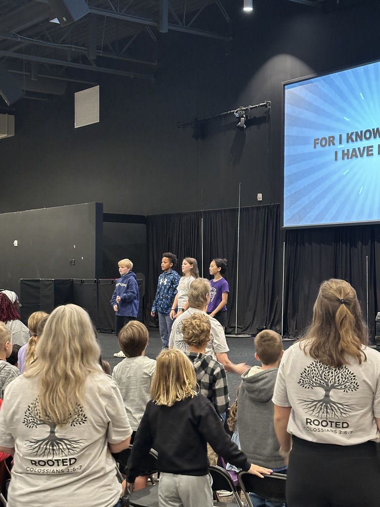 elementary students singing songs during chapel
