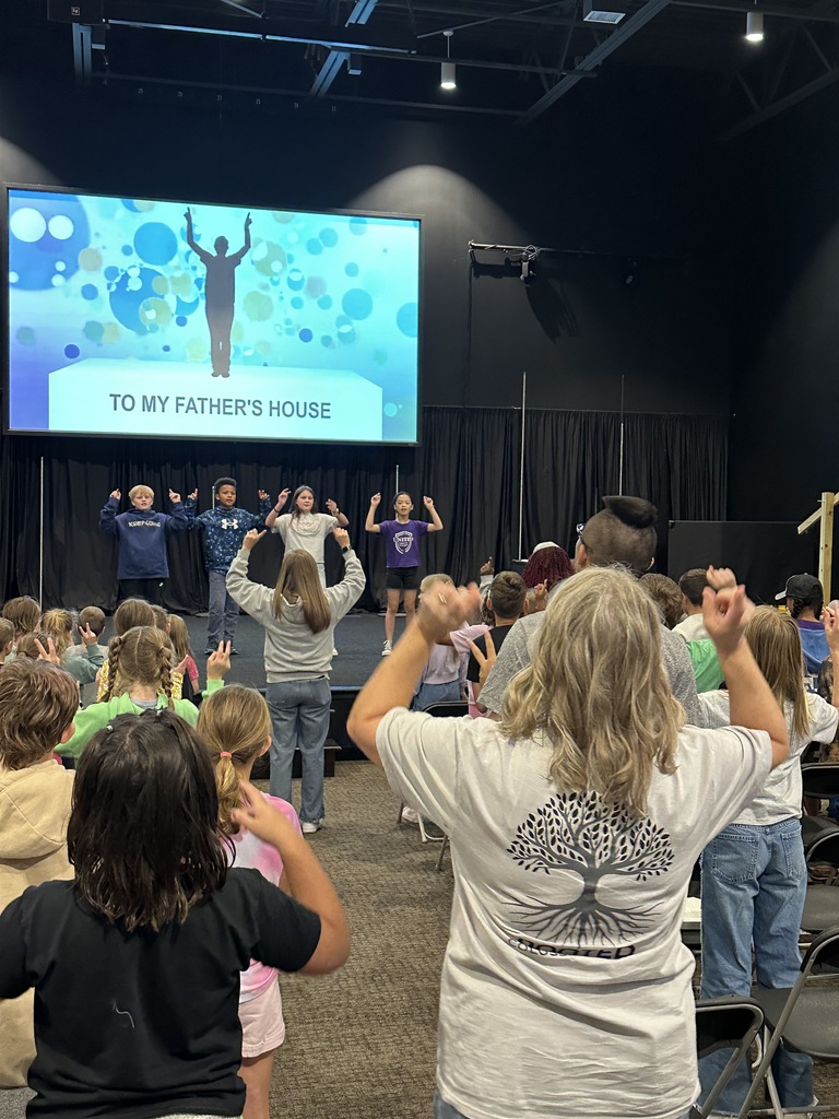 elementary students singing songs during chapel