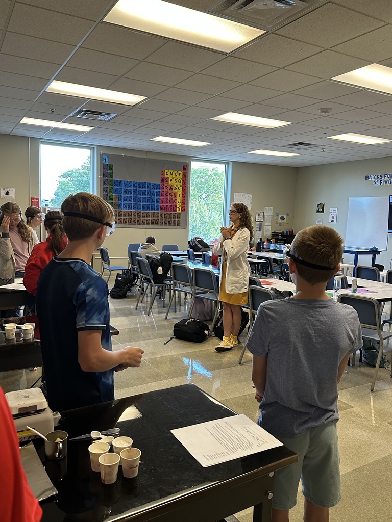 science teacher speaking to her students in a lab
