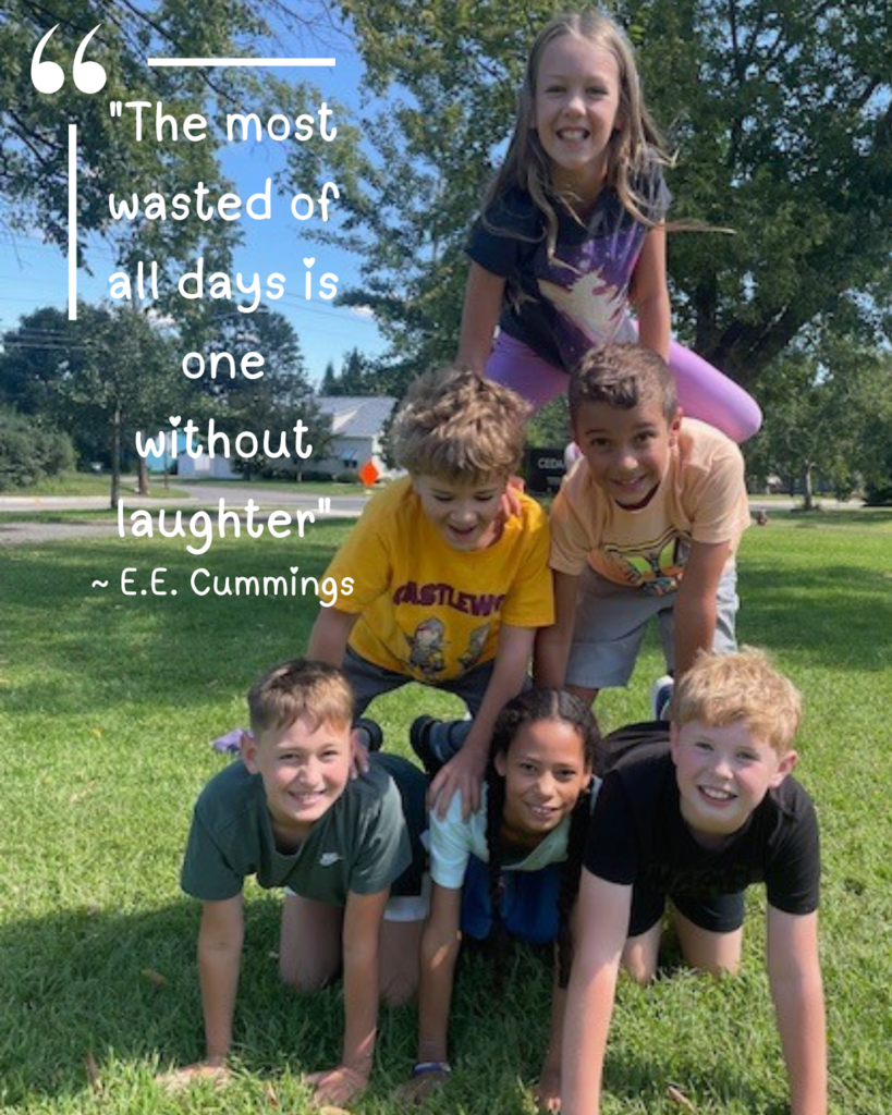 six elementary students in a human pyramid