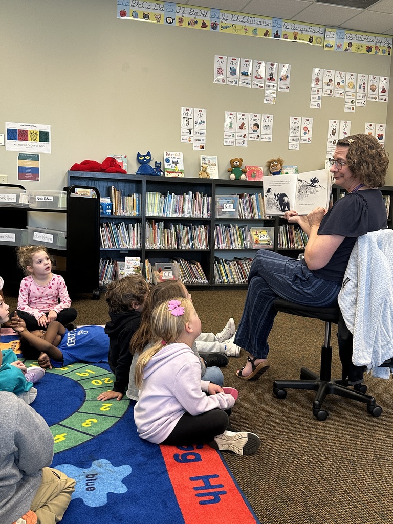 librarian reading kindergarten students a story