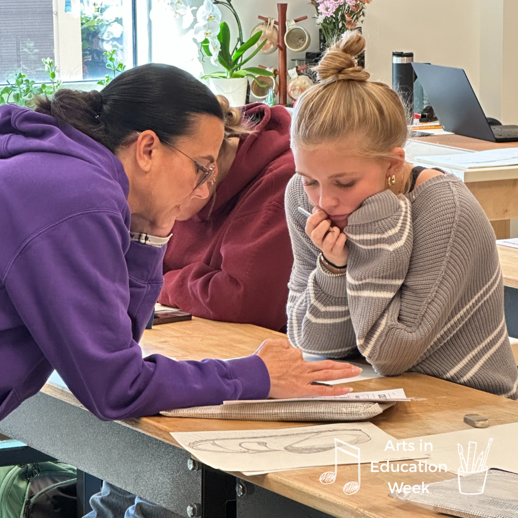 art teacher working one-on-one with a student