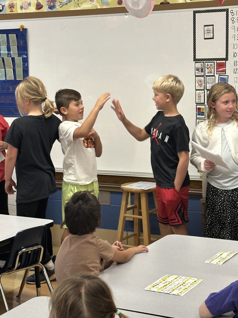 two boys giving each other high-fives