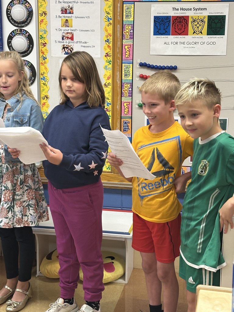 3rd graders reading in front of a kindergarten class