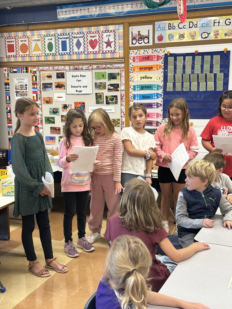 3rd graders reading in front of a kindergarten class
