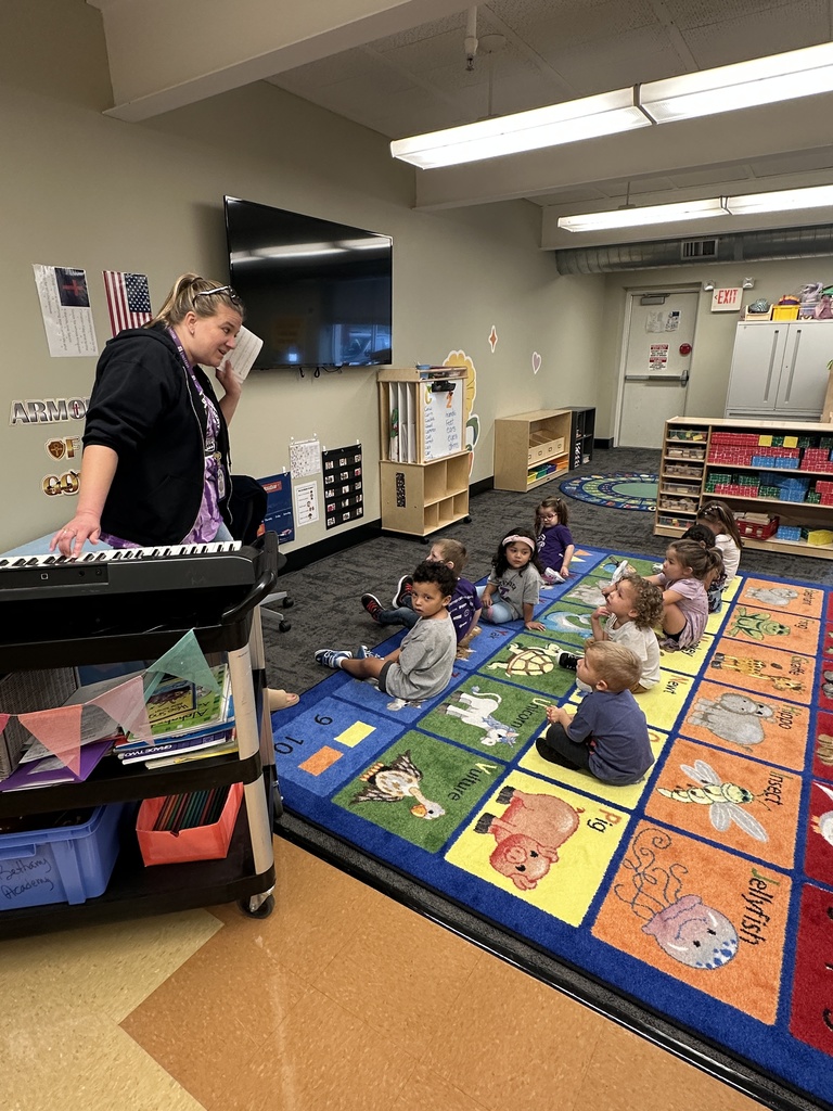 music teacher singing a song with PreK students