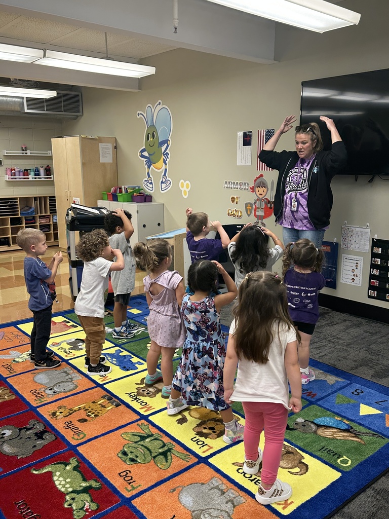 music teacher singing a song with PreK students