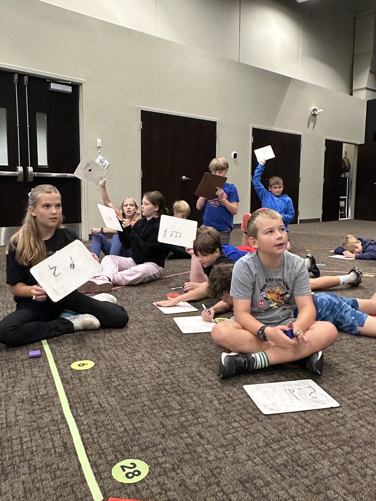 5th grade students writing music notes on whiteboards