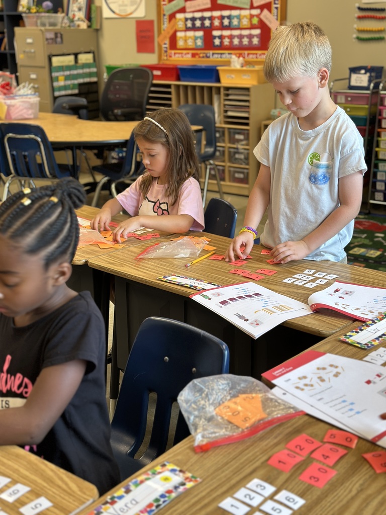 students sitting at their desk working on a math assignment