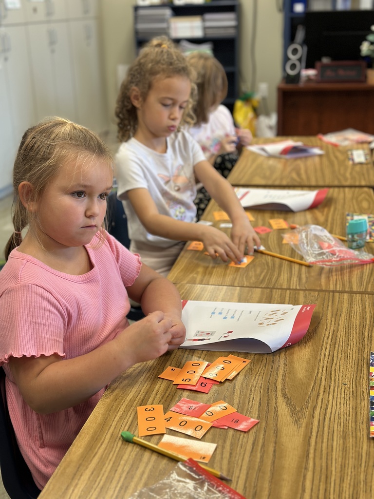 students sitting at their desk working on a math assignment