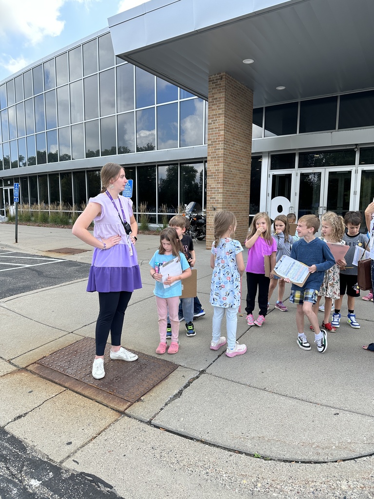 first grade teacher and students walking out of the building