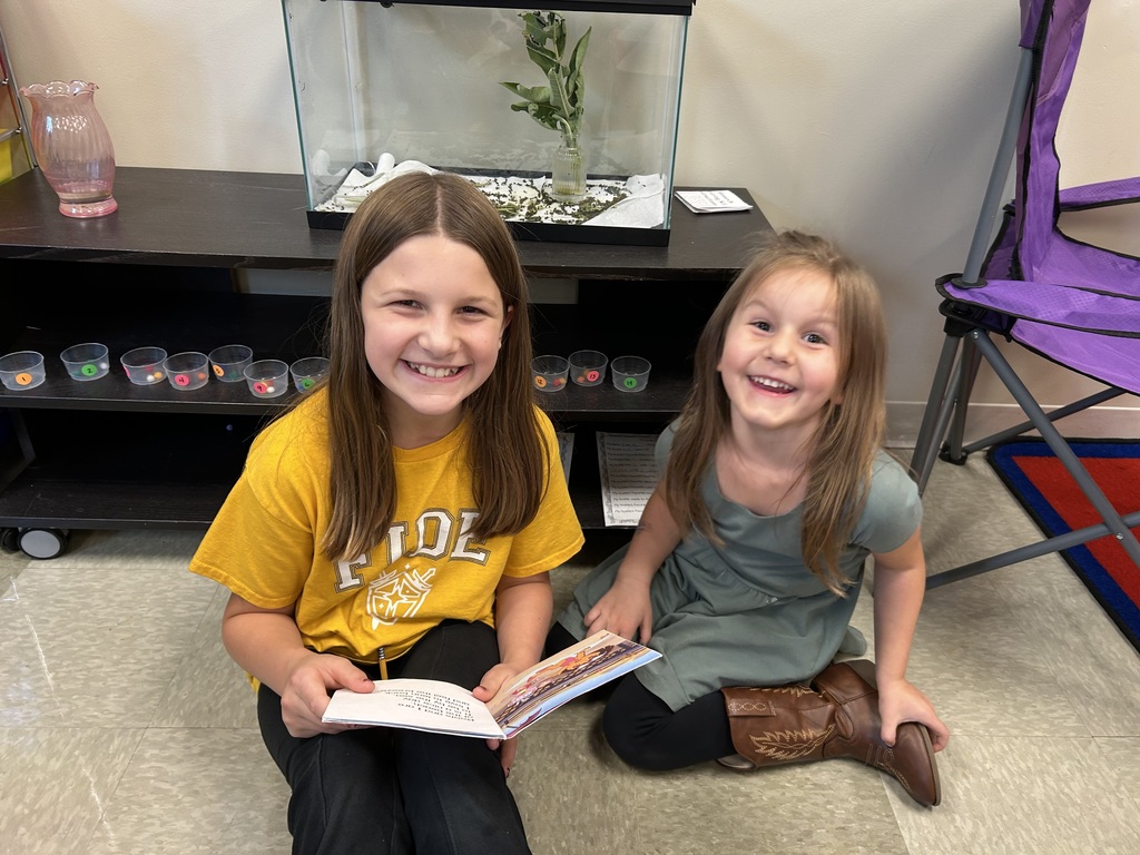 5th grade and kindergarten "Buddies" reading and doing activities to get to know each other