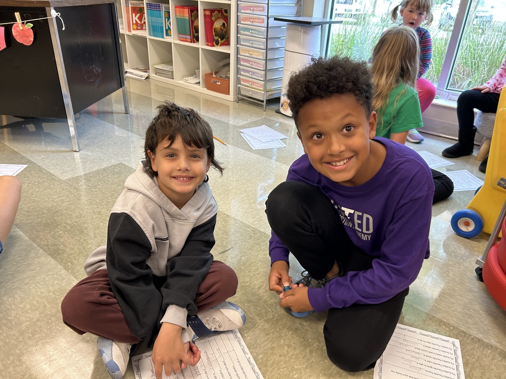5th grade and kindergarten "Buddies" reading and doing activities to get to know each other