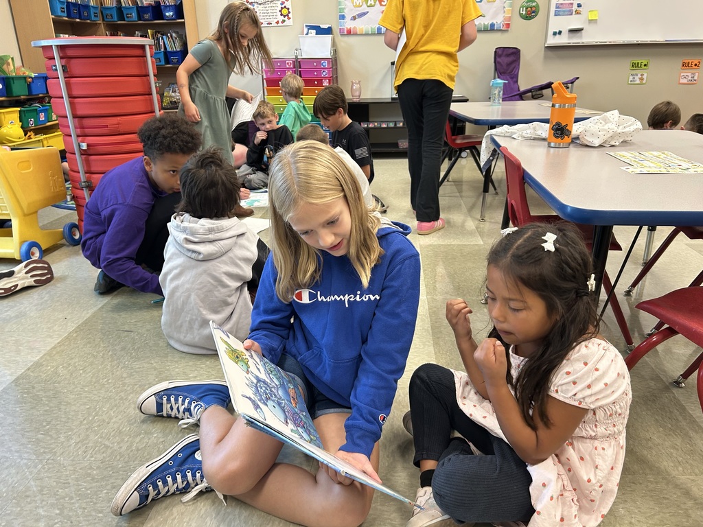 5th grade and kindergarten "Buddies" reading and doing activities to get to know each other