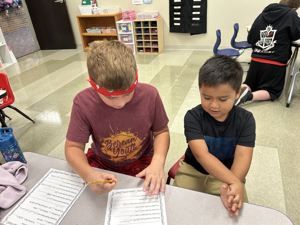 5th grade and kindergarten "Buddies" reading and doing activities to get to know each other