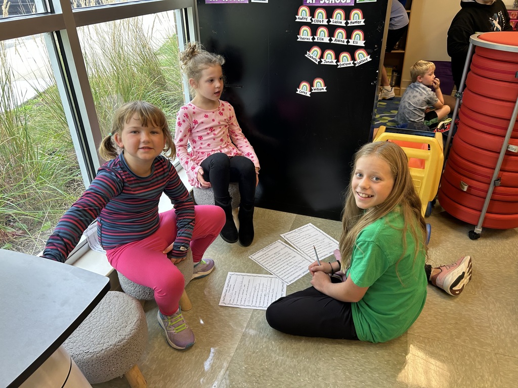 5th grade and kindergarten "Buddies" reading and doing activities to get to know each other