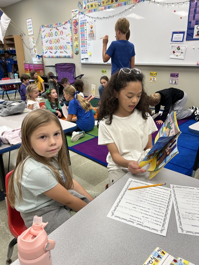 5th grade and kindergarten "Buddies" reading and doing activities to get to know each other