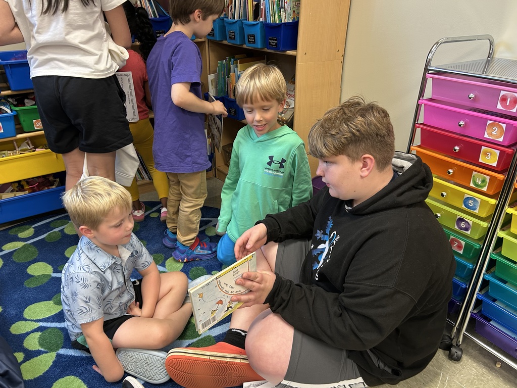 5th grade and kindergarten "Buddies" reading and doing activities to get to know each other
