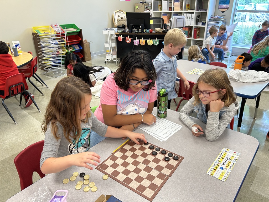 5th grade and kindergarten "Buddies" reading and doing activities to get to know each other