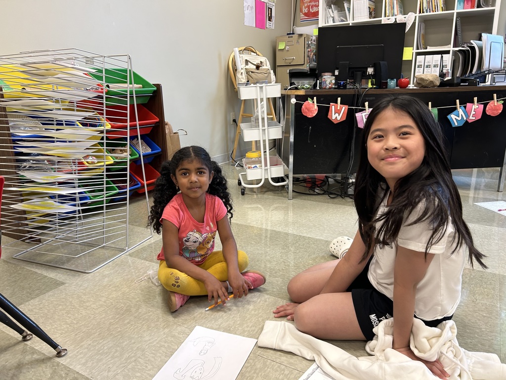5th grade and kindergarten "Buddies" reading and doing activities to get to know each other