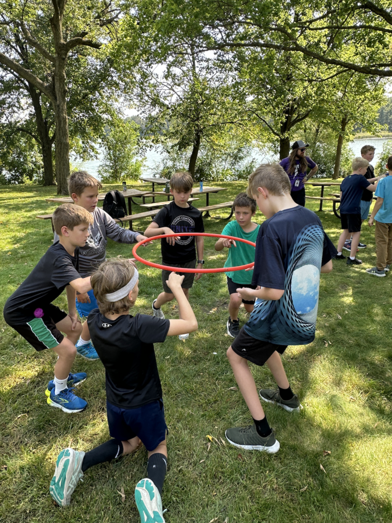 6th grade boys doing a team-building exercise