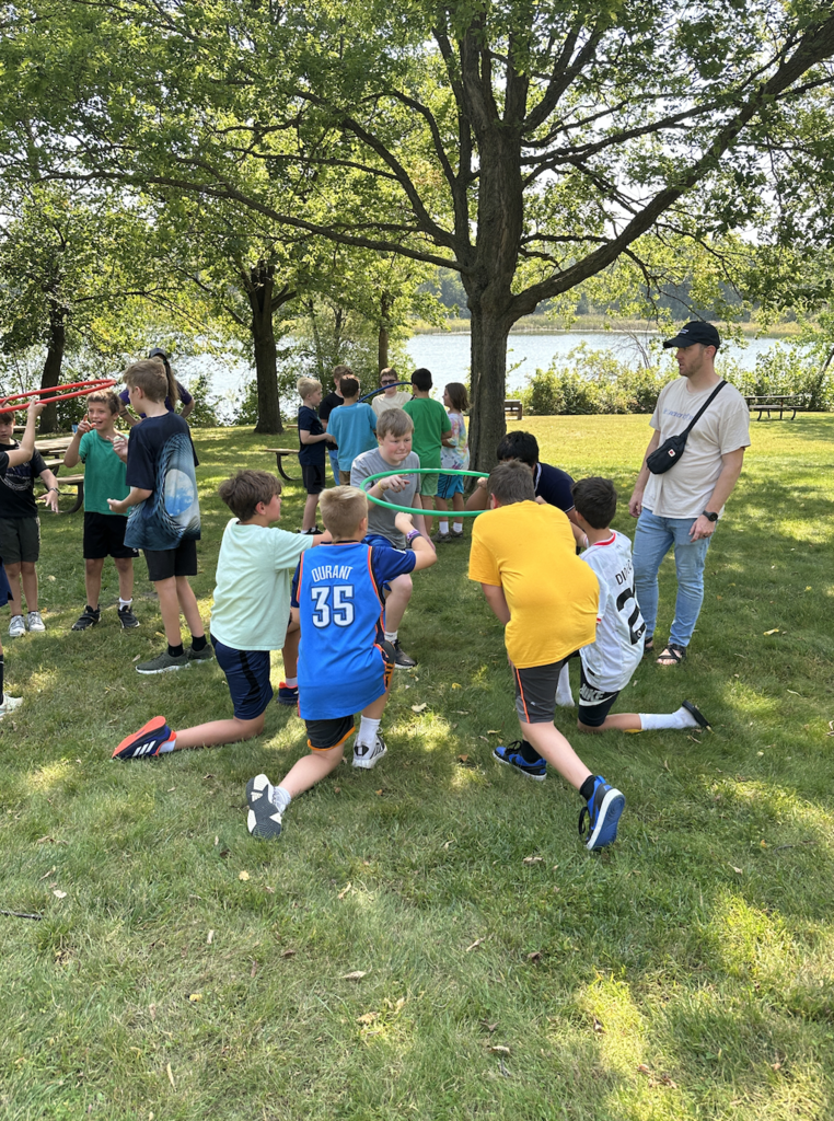 6th grade boys doing a team-building exercise