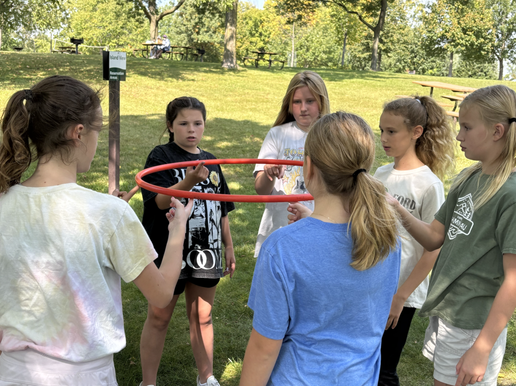 6th grade girls doing a team-building exercise
