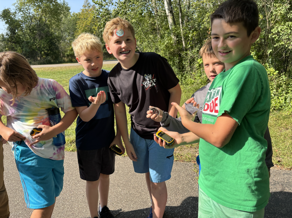 a group of 6th grade boys geocaching