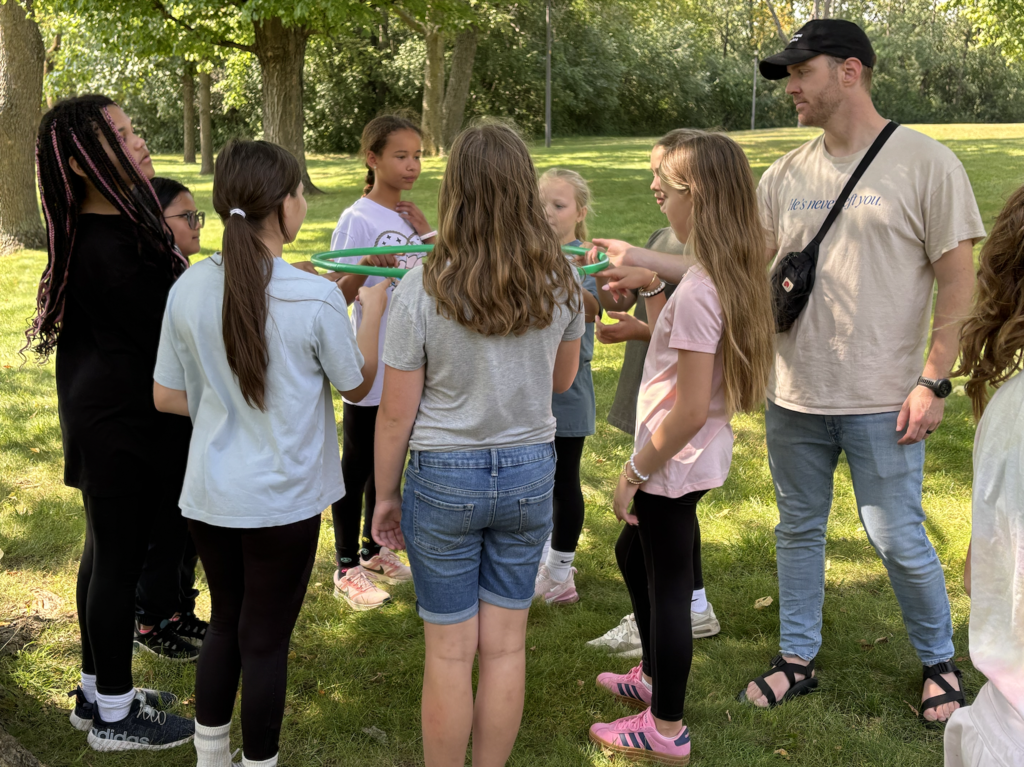 6th grade girls doing a team-building exercise