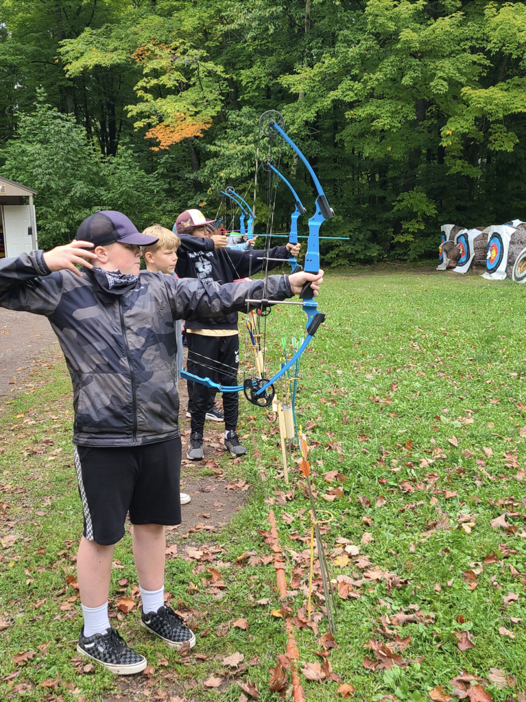 group of 7th and 8th grade boys doing archery