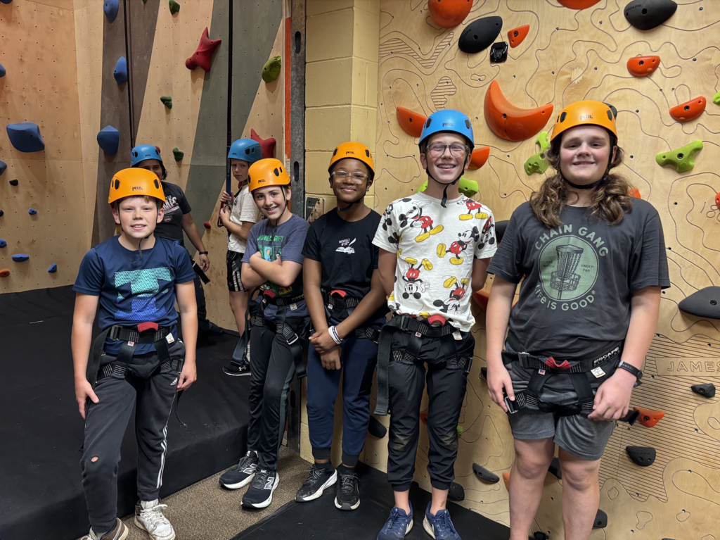 group of 7th and 8th grade boys rock climbing