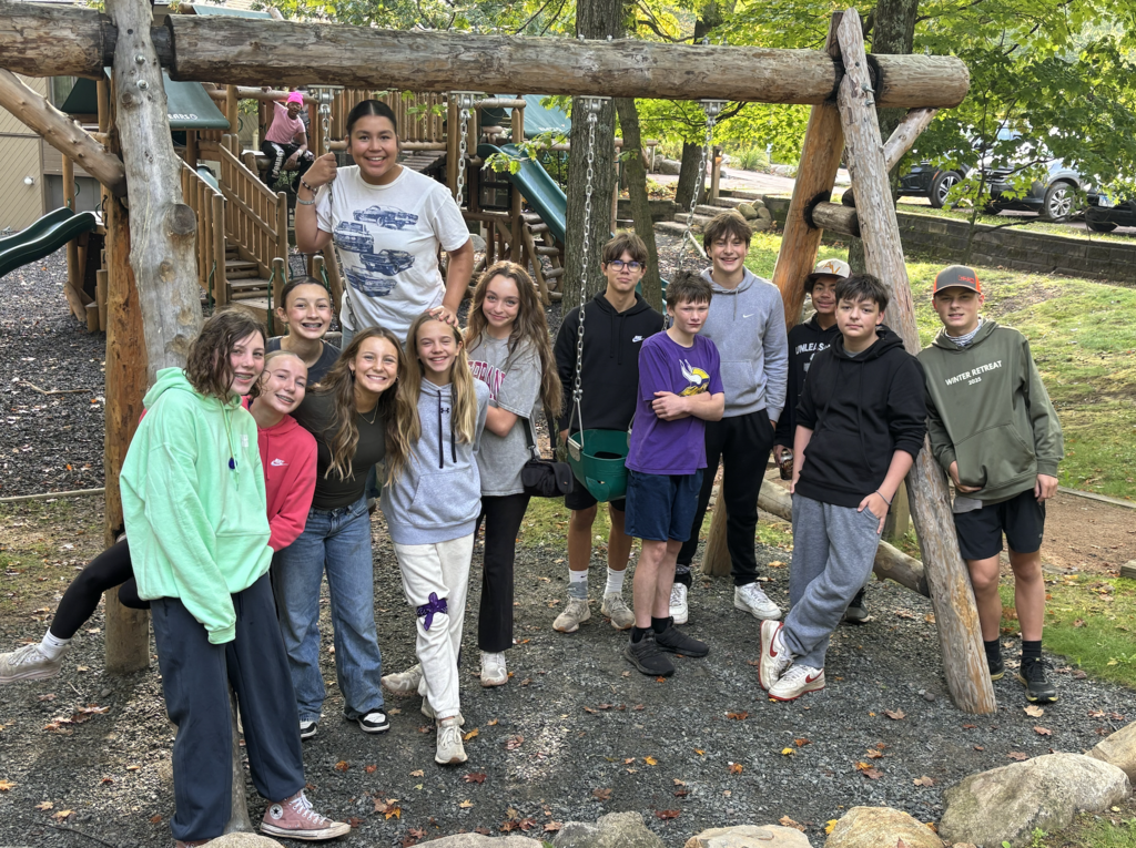 group of 7th and 8th graders on a swingset