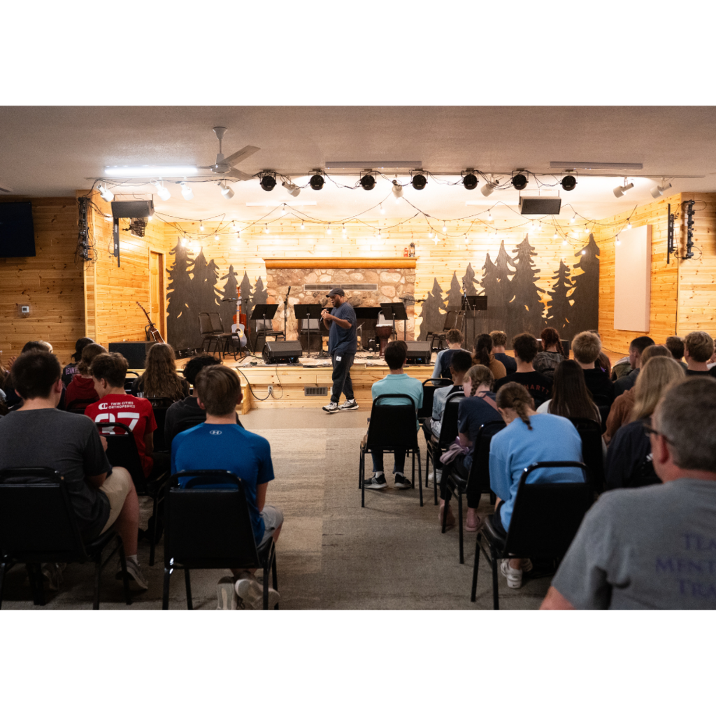 high school students listening to a speaker during a chapel service