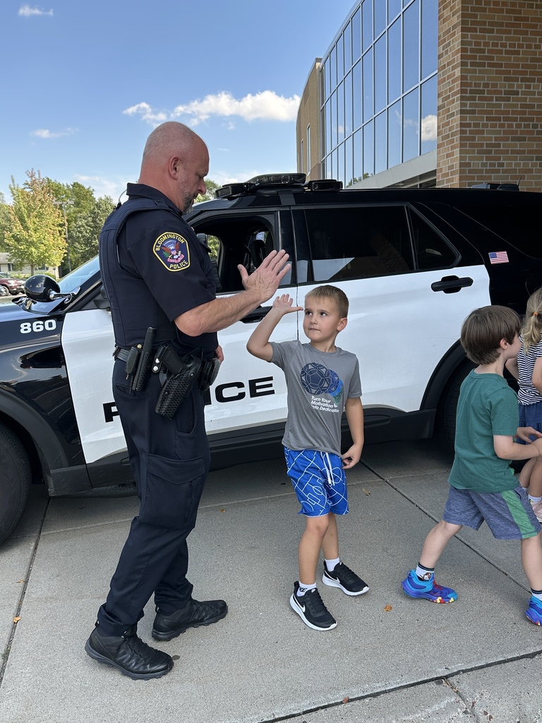 student giving a high five to a police officer