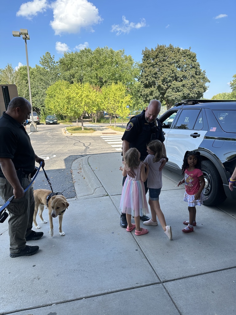 students hugging a police officer