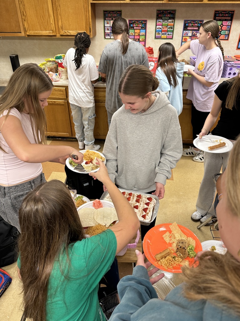 students serving up pieces of cake