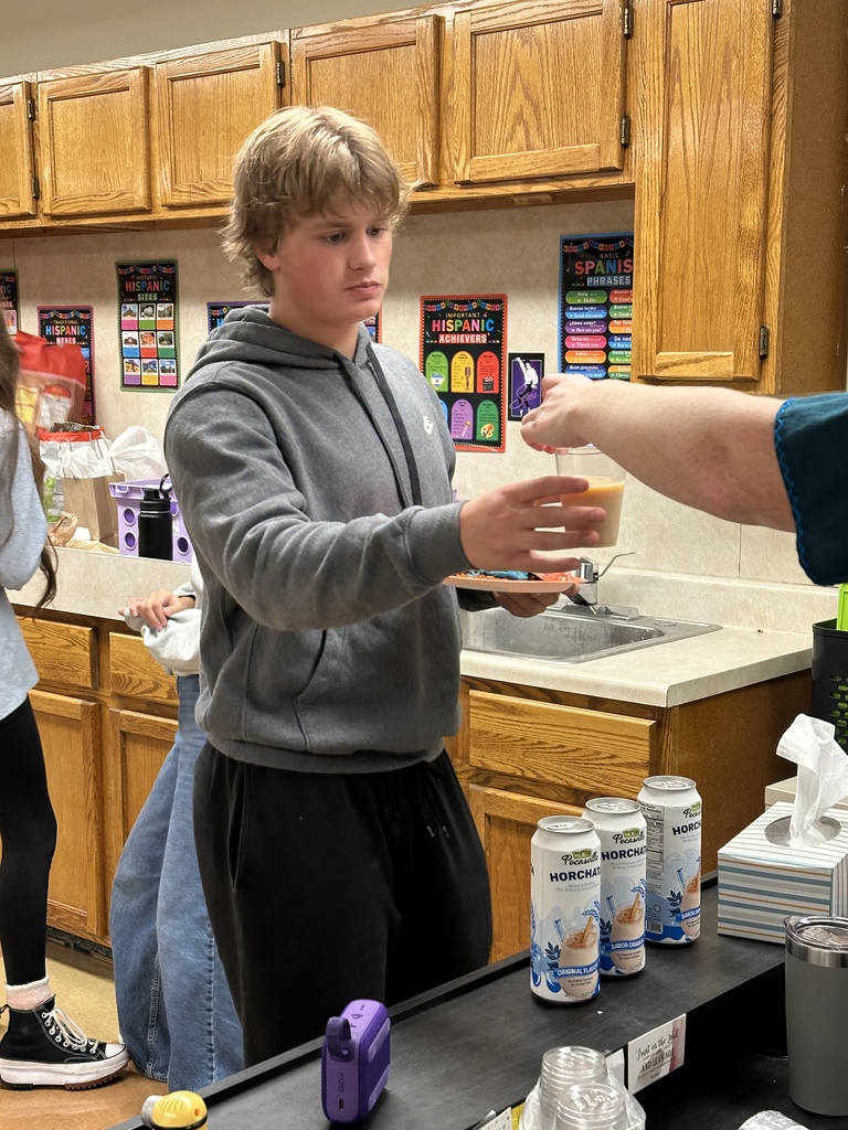 student being served a glass of horchata