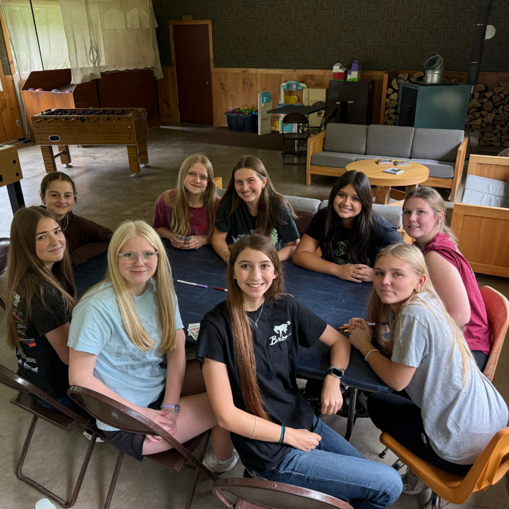 group of high school girls hanging out around a table