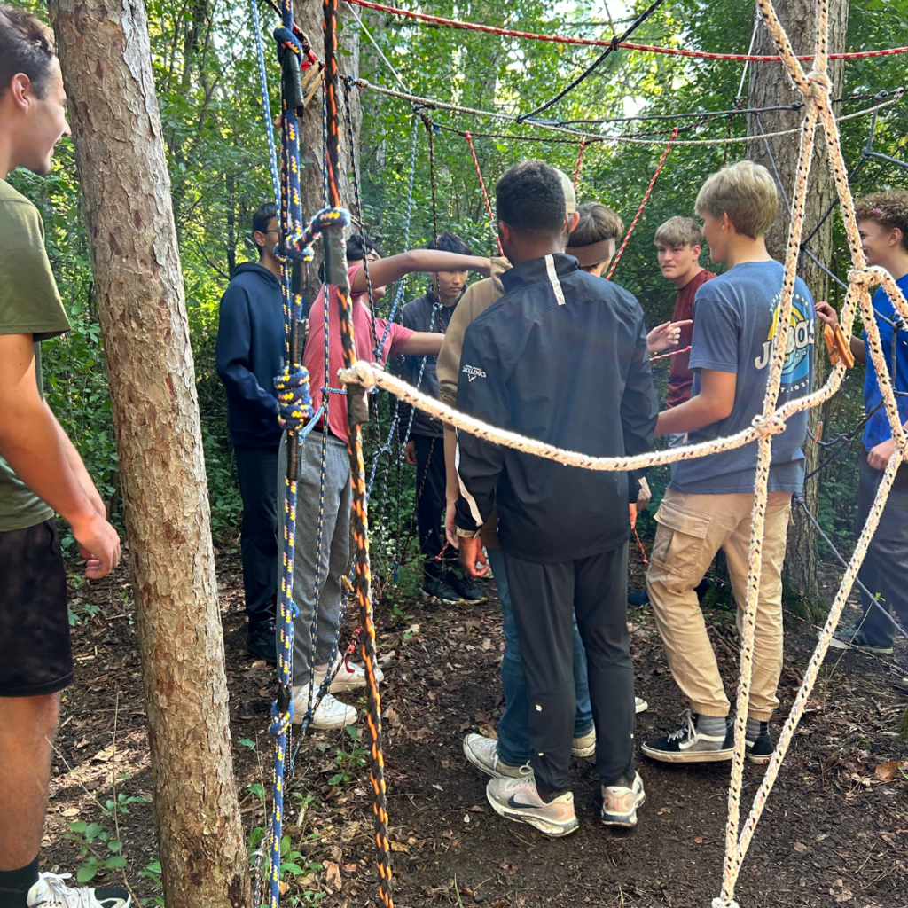 group of high school boys doing a team-building exercise