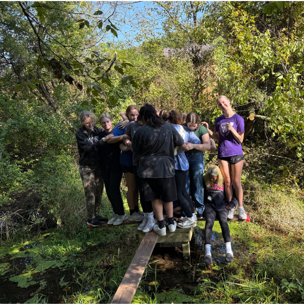 high school girls doing a team-building exercise